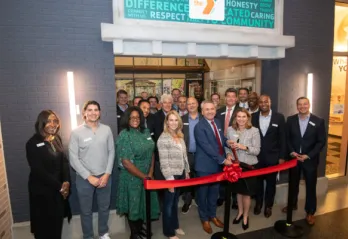 board members and senior leadership cutting ribbon at YMCA Junior Achievement at Storefront 