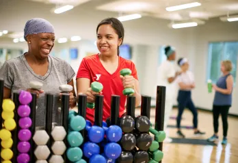 Y staff with member in exercise room