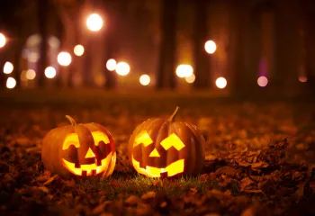 two smiling carved pumpkins