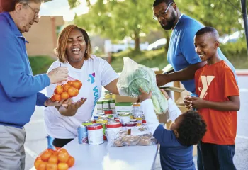 a volunteer distributing food at a food distribution 