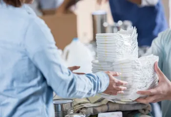 a picture of diapers being handed to someone 