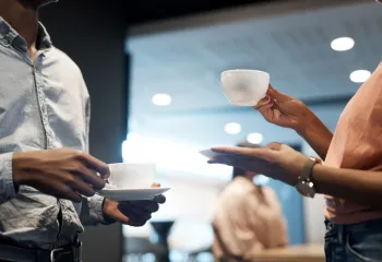 people with cups of coffee chatting