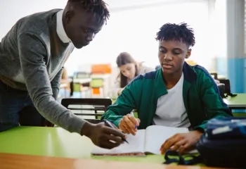 teacher helping a student with their works