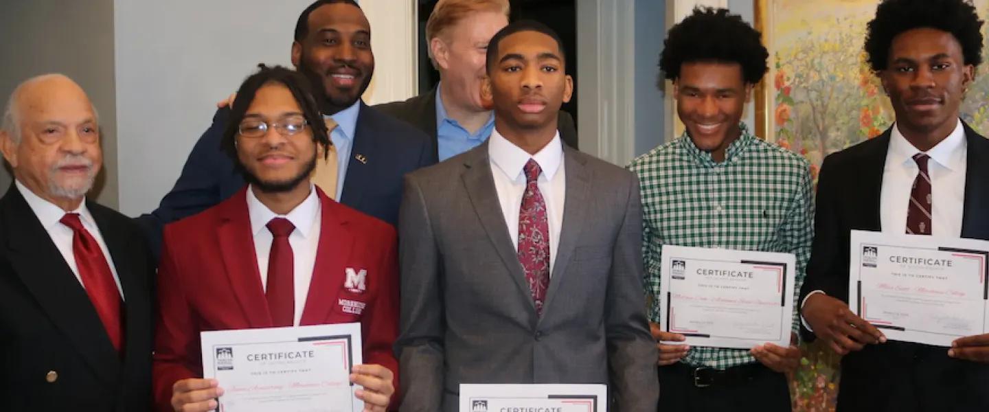 group of people standing receiving a certificate 