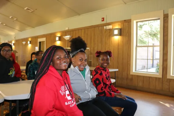 group of 3 teens smiling 
