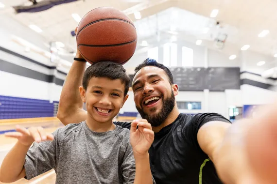 Dad and son playing basketball