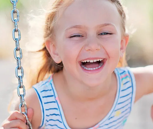 Smiling child on swing