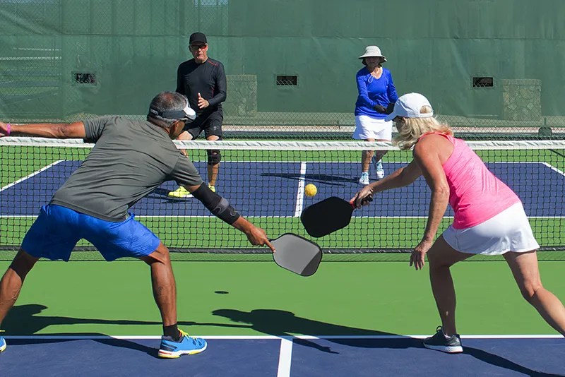 Adults playing pickleball