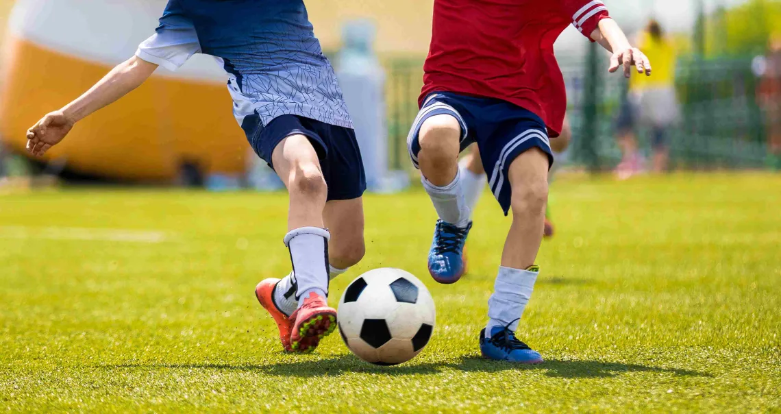 soccer players going after ball