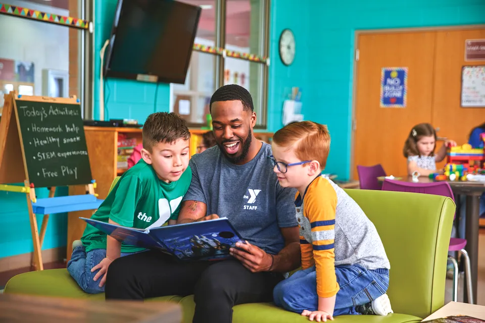 afterschool staff reading to participants 