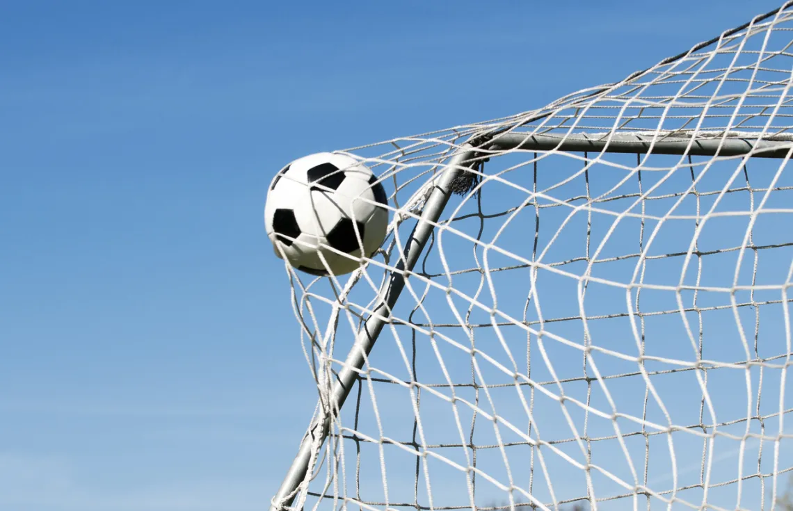 soccer ball going into back of the net