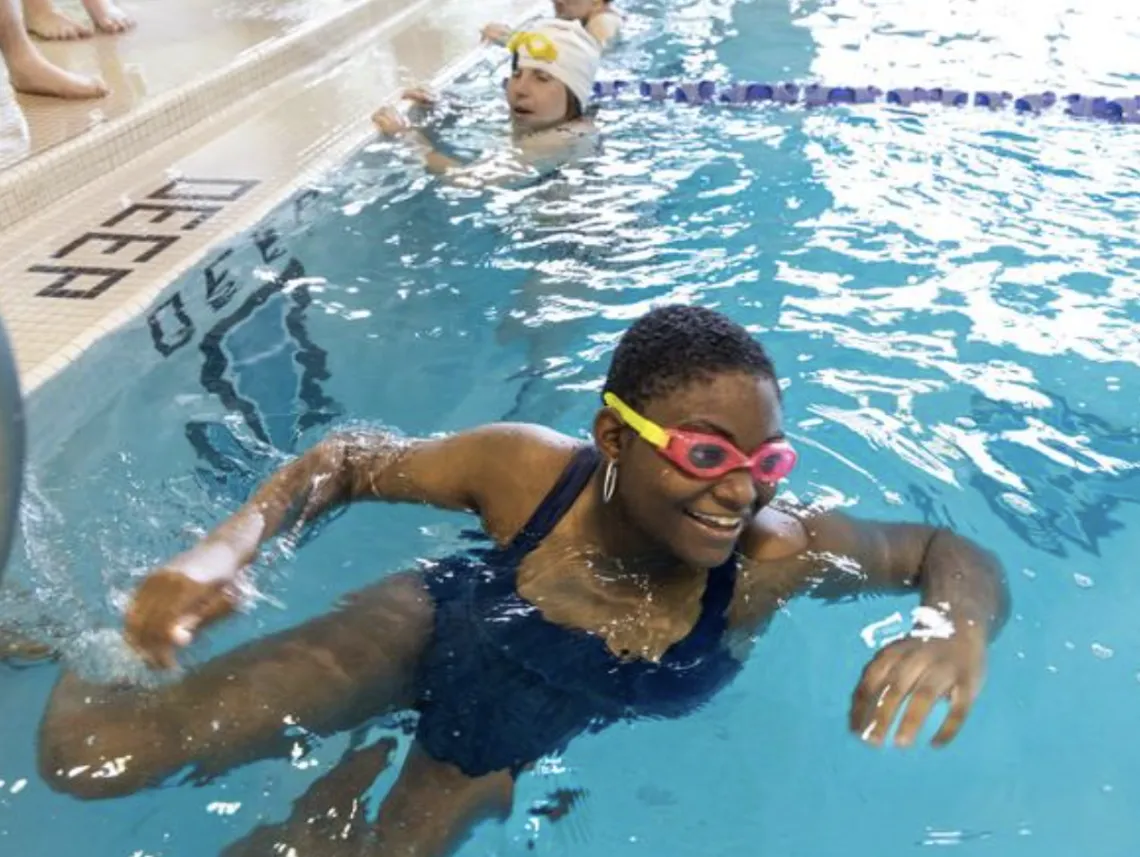 Smiling Girl Swimming In Pool
