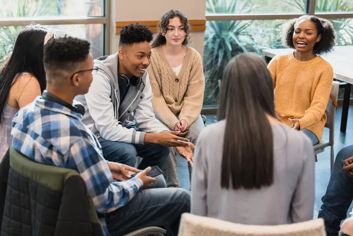 group of teens in a circle at a mentoring session