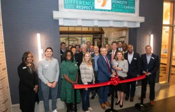 board members and senior leadership cutting ribbon at YMCA Junior Achievement at Storefront 