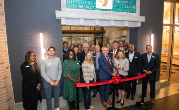 board members and senior leadership cutting ribbon at YMCA Junior Achievement at Storefront 