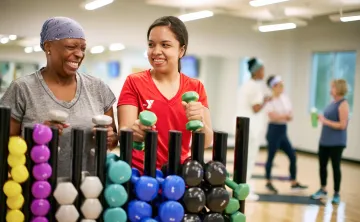 Y staff with member in exercise room